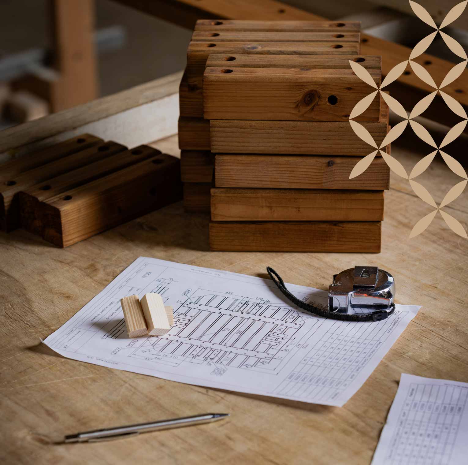 Workshop table with measuring tape, wood planks and paper